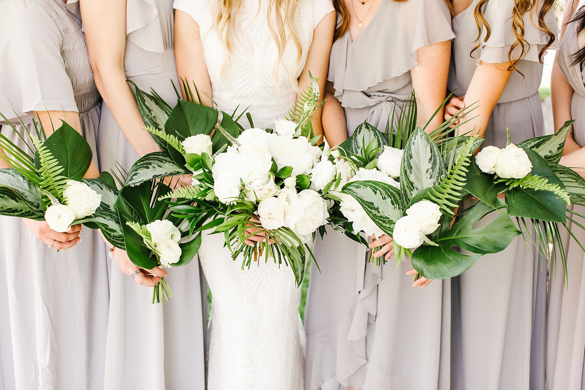 Dove Gray bridesmaids dresses and tropical bouquets