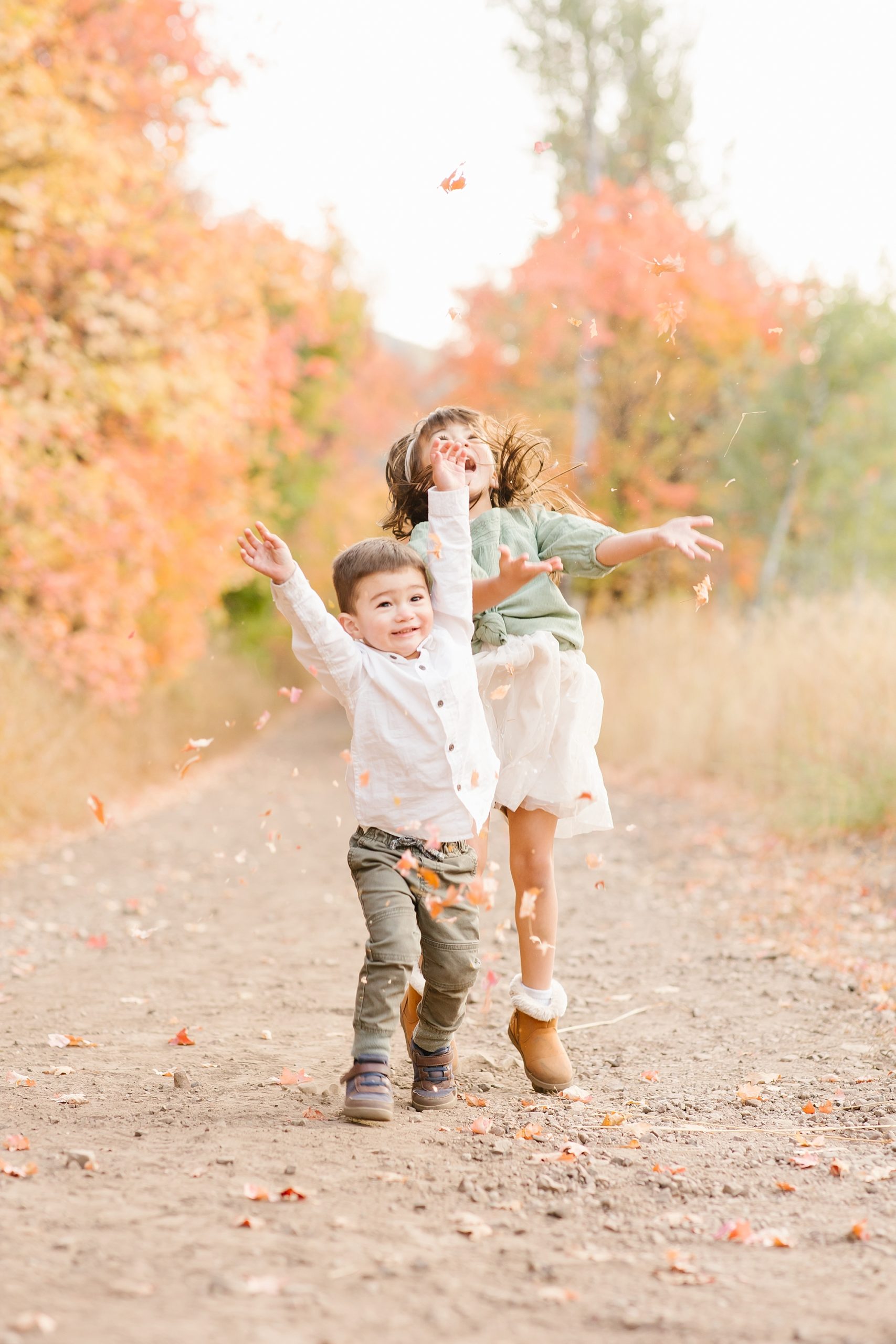 Kids playing in the fall leaves is the perfect way to end your family portrait session!!