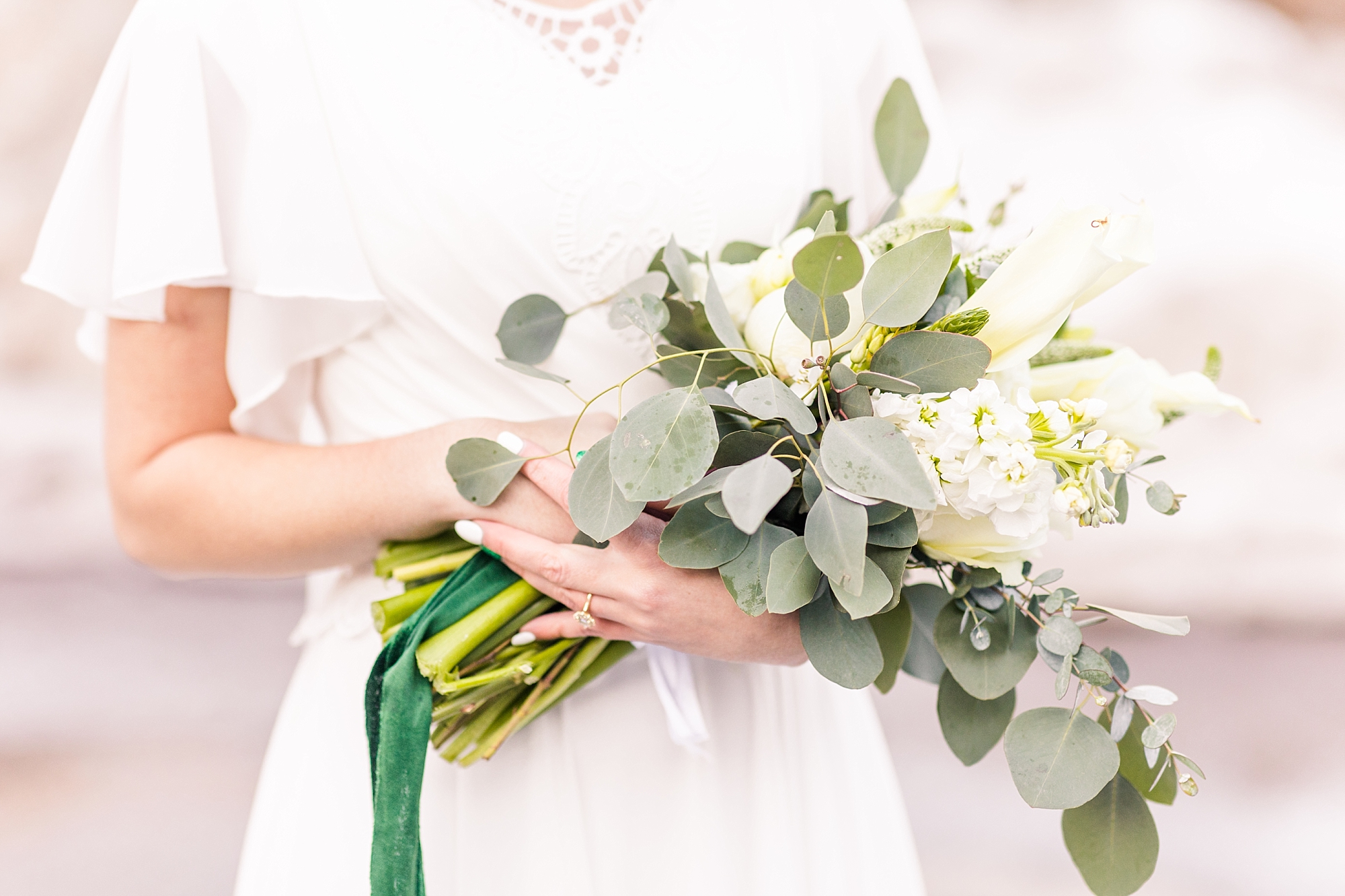 Simple and elegant white wedding bouquet with splashes of eucalyptus
