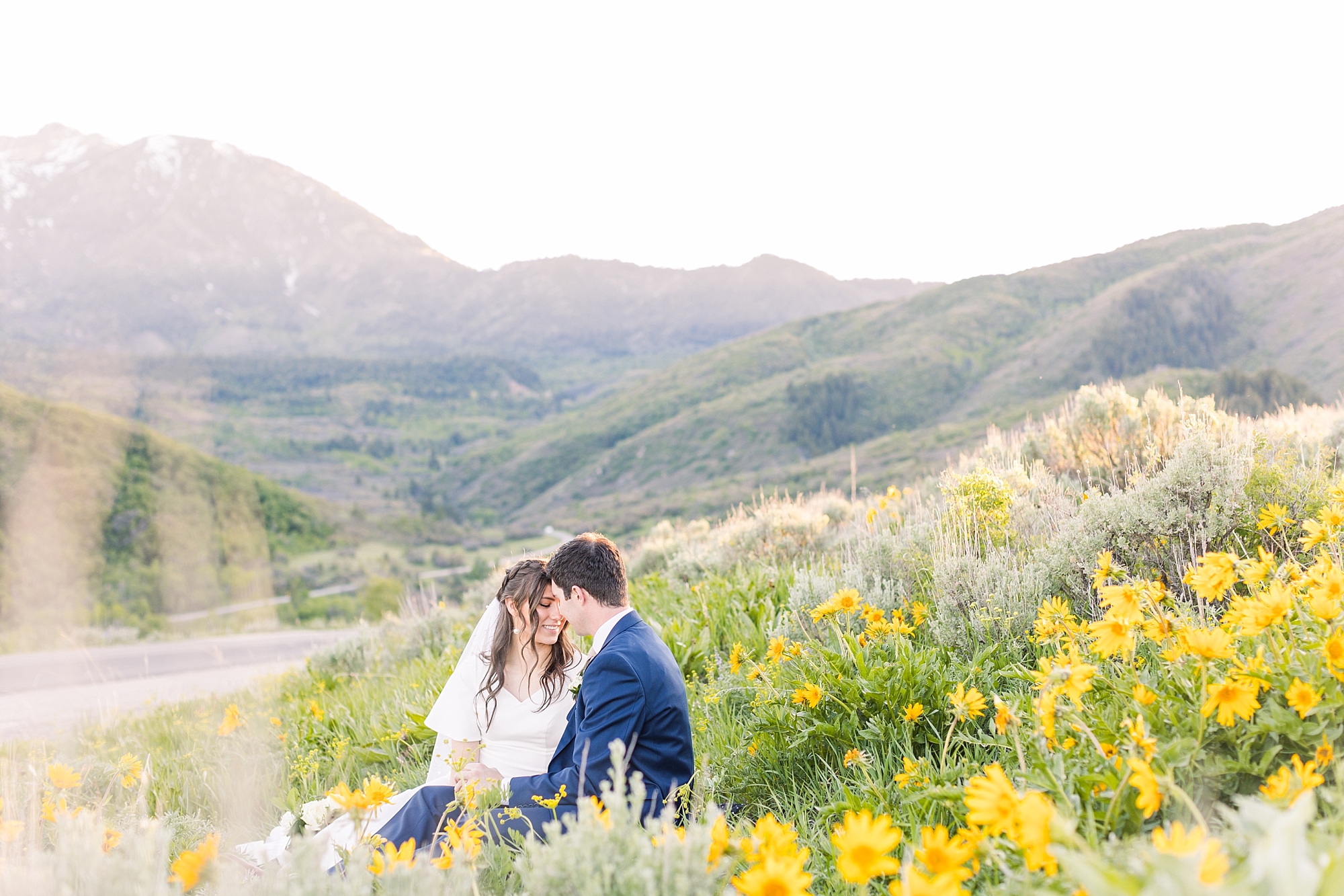 Contact me for your Utah mountains summer formals session with beautiful vibrant yellow wild flowers covering the rolling mountain hills!