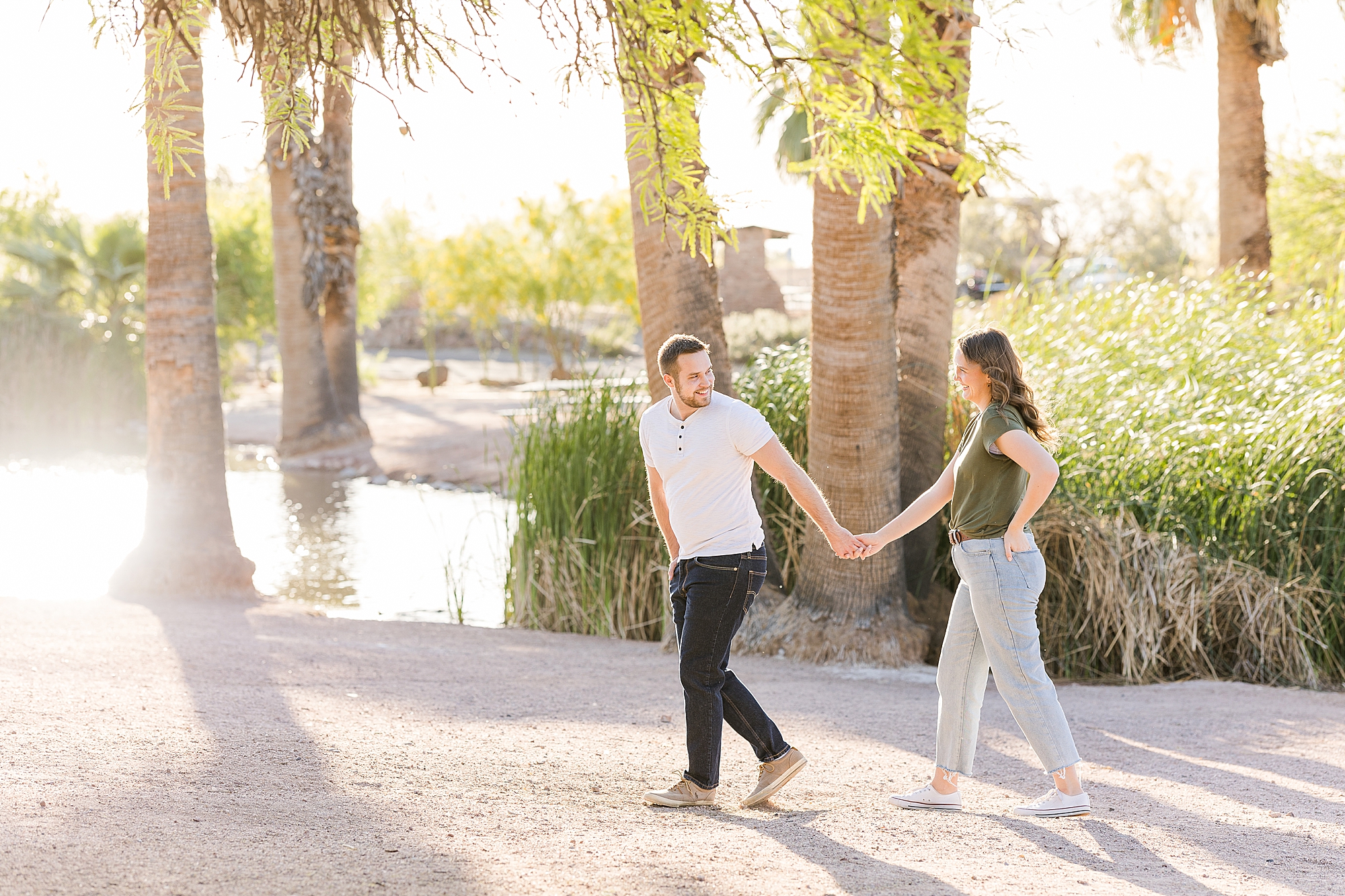 A shot of the couple walking along the park's pathway during their engagement session at Papago Park
