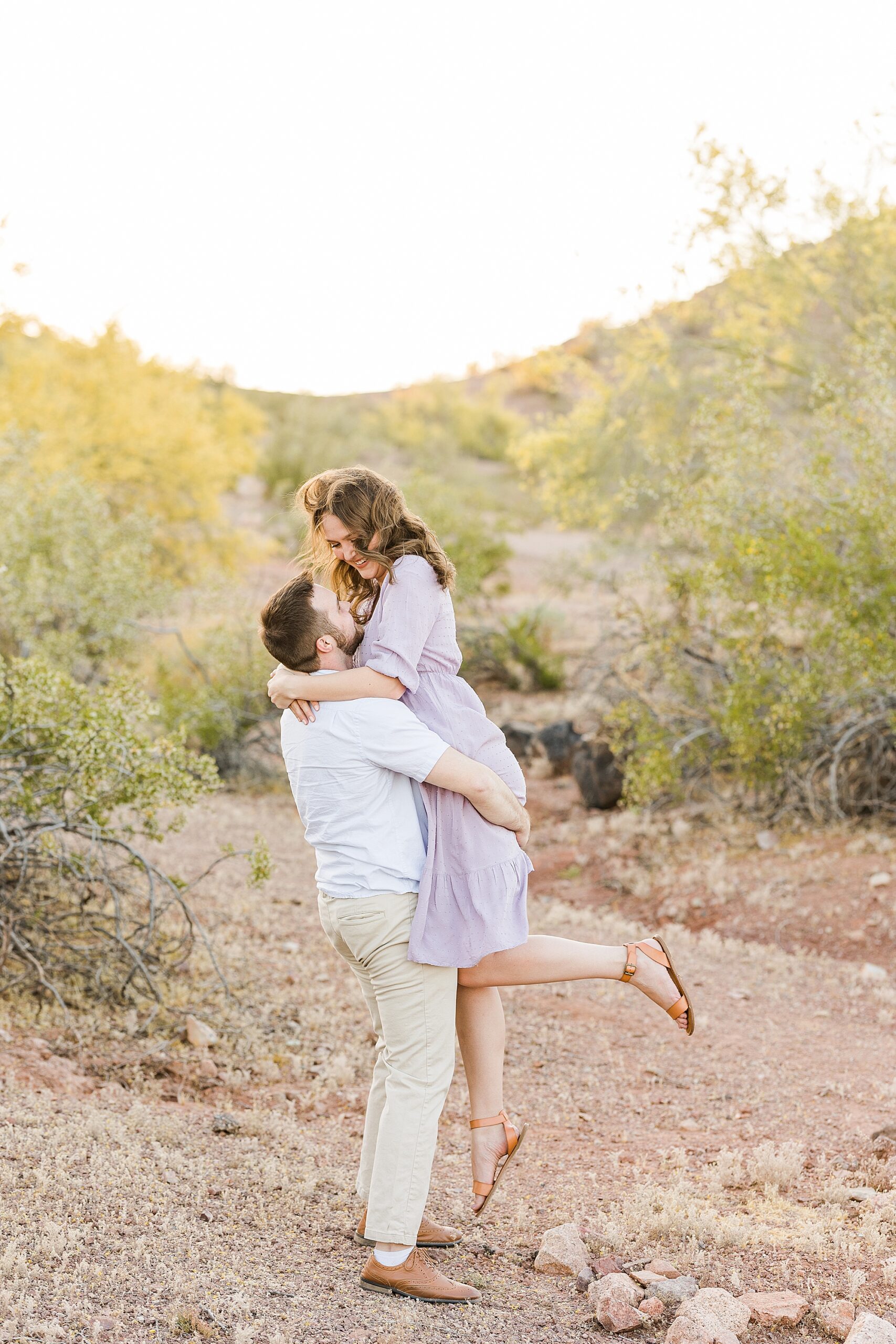 A scenic shot of the park's natural red rock formations during their engagement session at Papago Park
