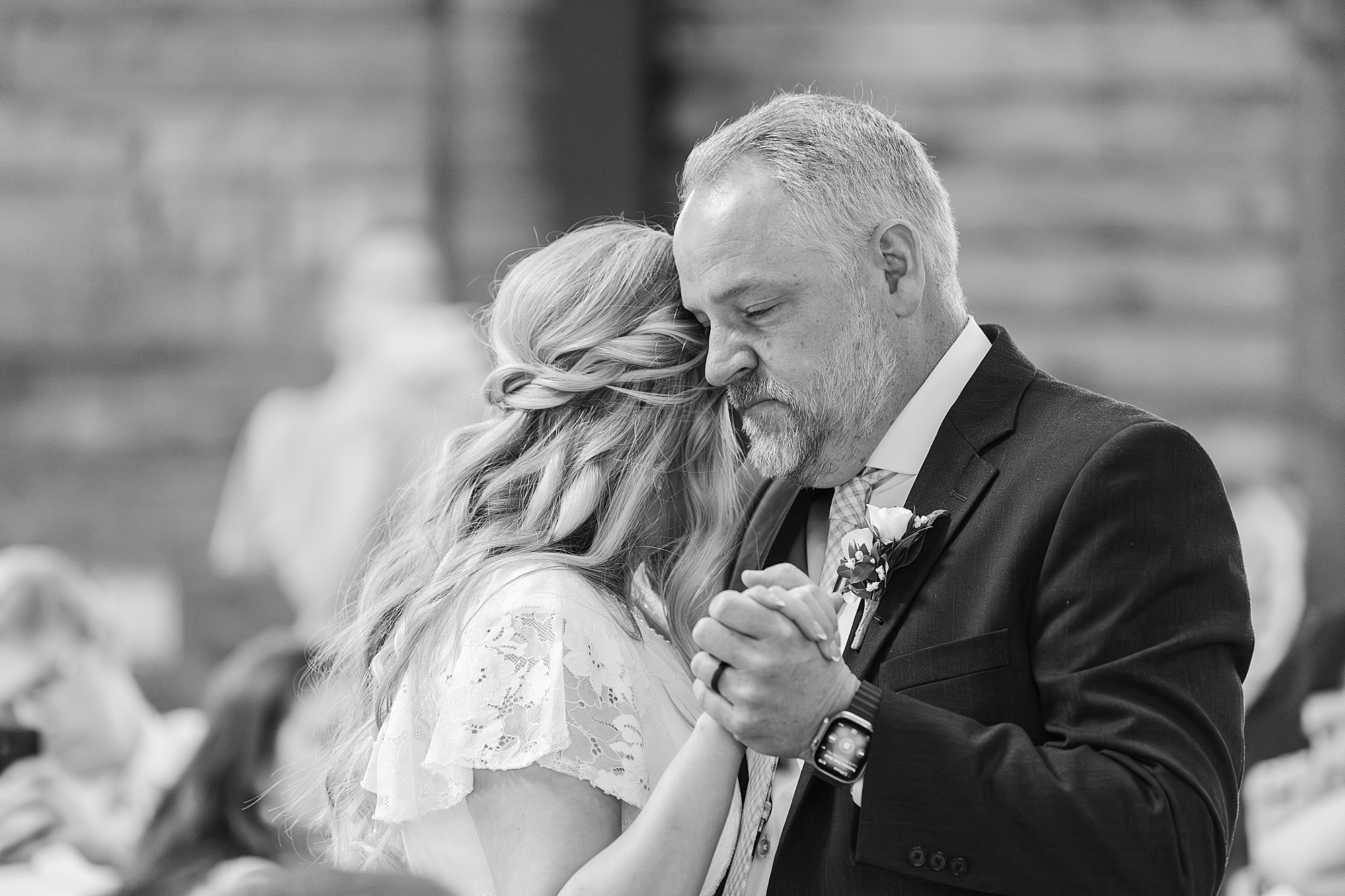 Bride embracing her father during an emotional moment
