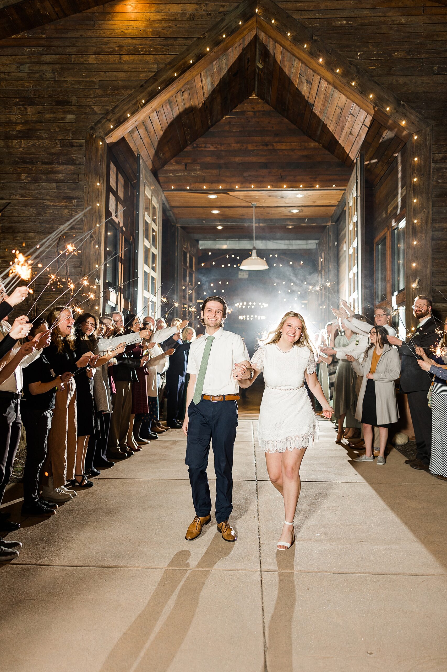 Guests lined up on both sides of the exit path, holding sparklers
