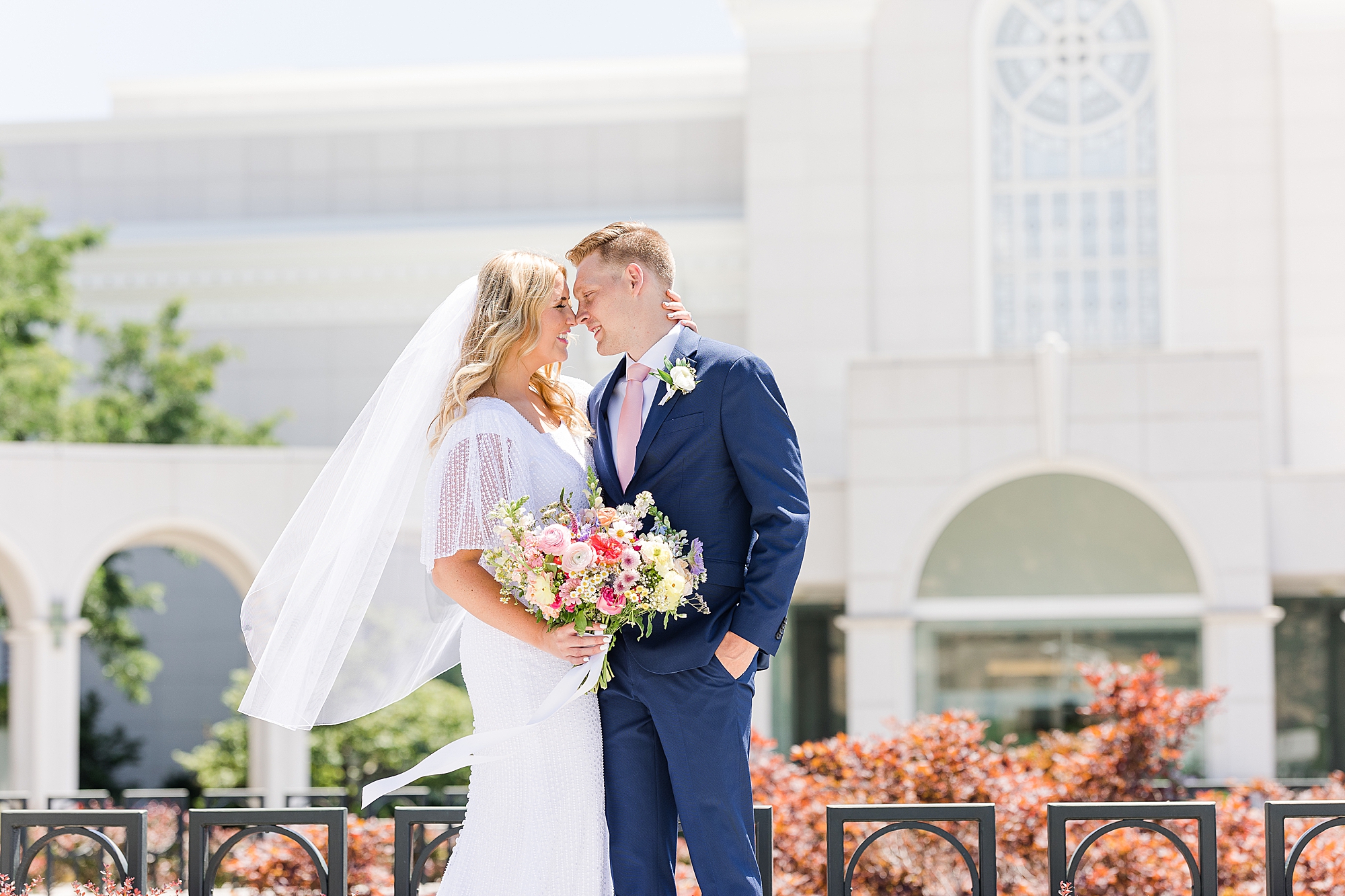 The bride and groom enjoying a moment outside the Bountiful Utah Temple