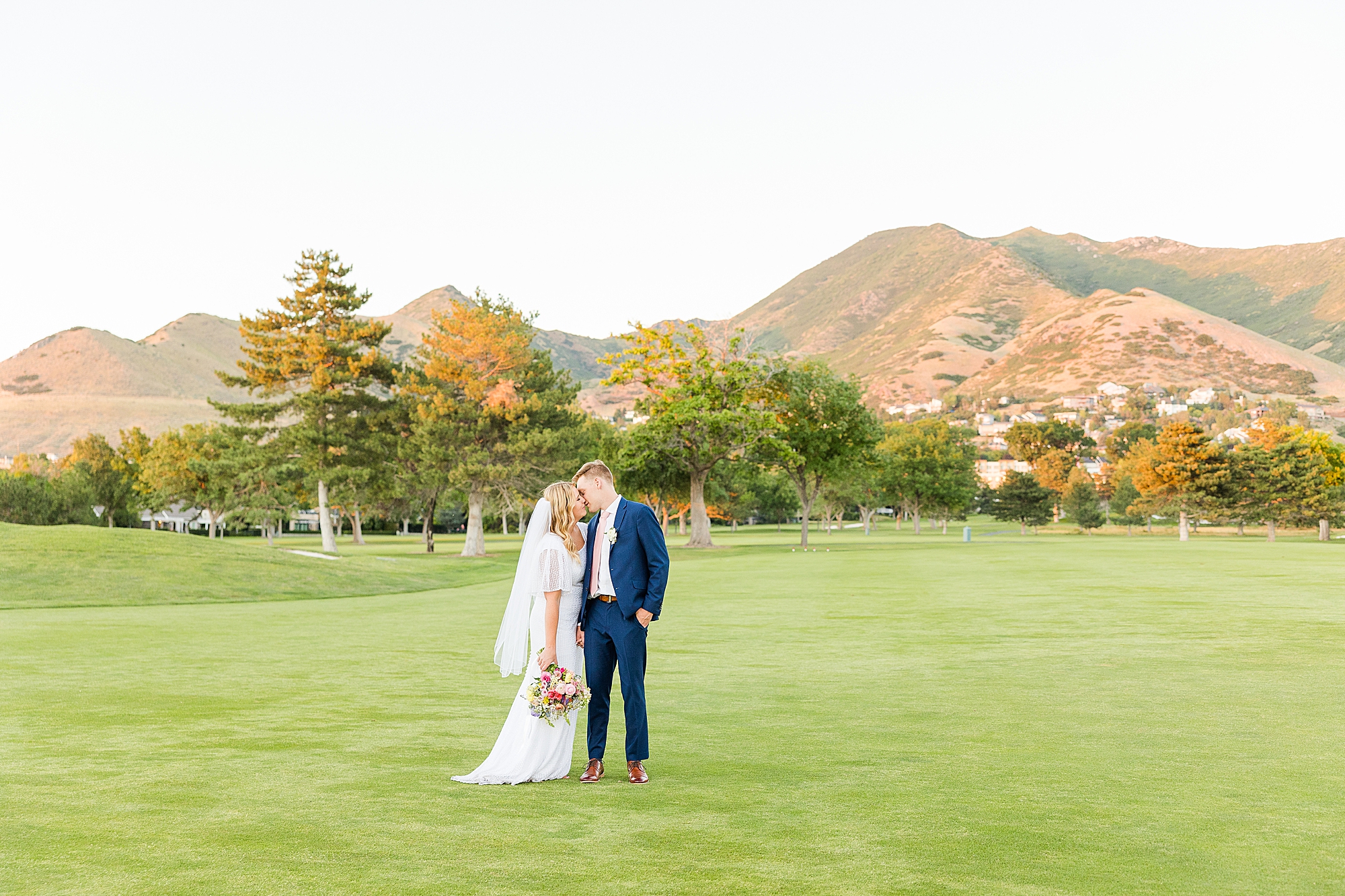 A picturesque view of the golf course at sunset, providing a breathtaking backdrop for the wedding celebration.
