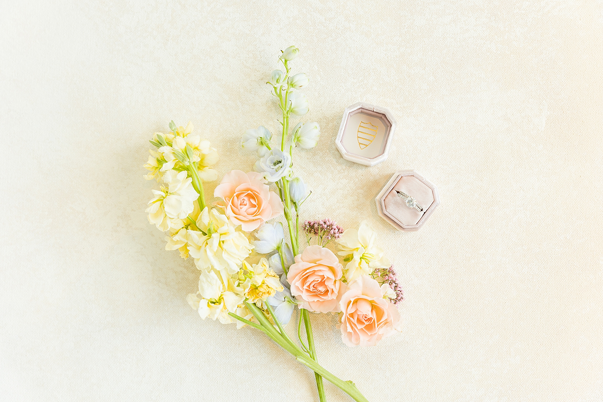 A whimsical photograph of the pastel wedding blooms and the bride's ring