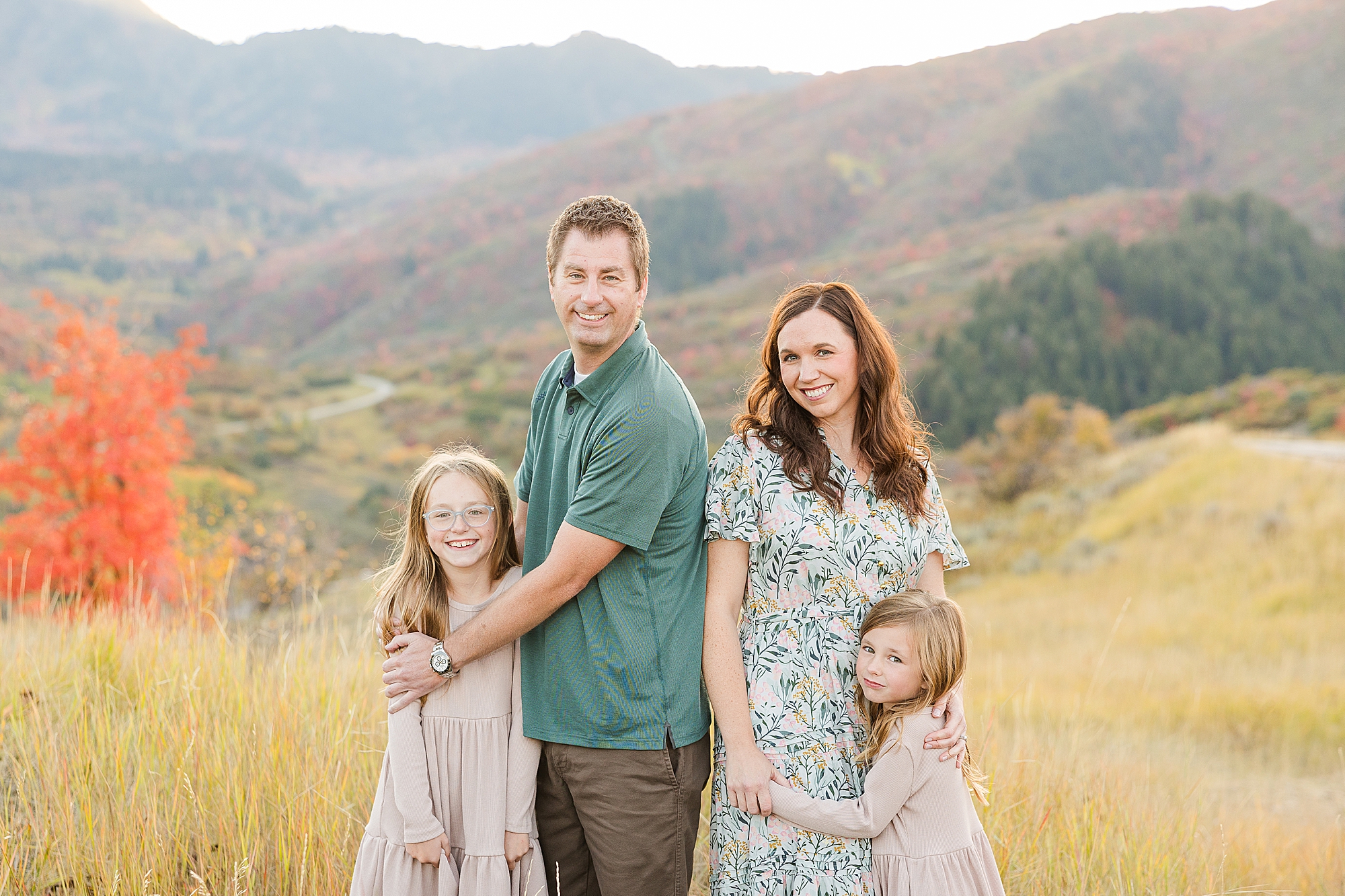 Radiant smiles of a family illuminated by fall colors at Snow Basin.