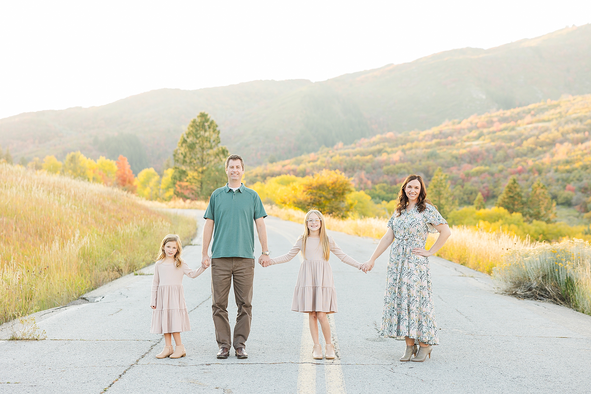 Vibrant fall foliage surrounds a loving family at Snow Basin.