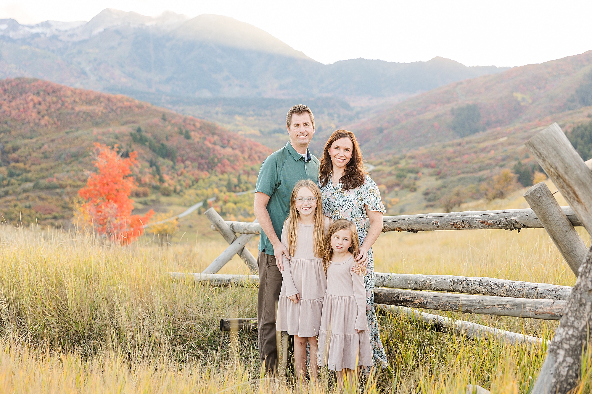 Heartwarming family embrace under Snow Basin's autumn sky.